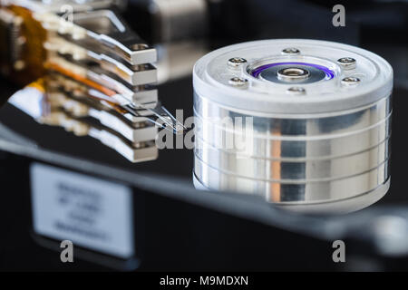 Hard disk drive inside close-up, actuator arm, read write head, ribbon cable. Stock Photo