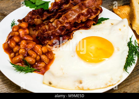 Fried eggs and bacon with spices isolated on white background Stock ...