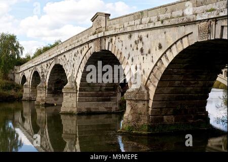 Stone Bridge at Atcham Shrewsbury, England over the river Severn showing water flowing under decorative sculptured arches in autumn Stock Photo