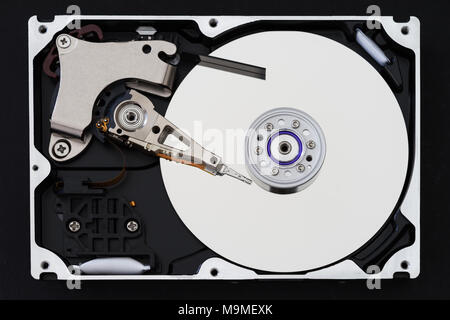Hard disk drive with removed cover, hdd inside flat view, spindle, actuator arm, read write head, platter, ribbon cable. Stock Photo