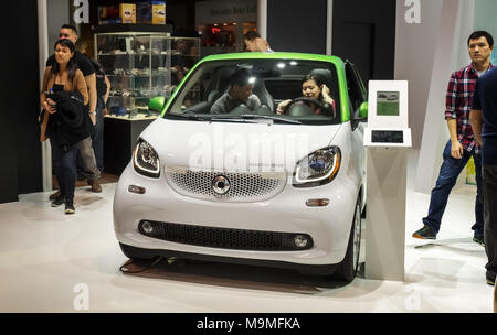 Toronto, Canada - 2018-02-19 : Visitors of 2018 Canadian International AutoShow testing the smart EQ fortwo electric microcar displayed on the Smart b Stock Photo