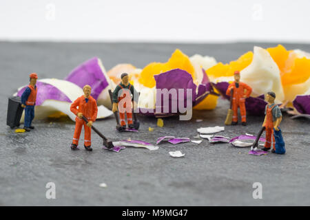 miniature worker people working on egg cleaning concept Stock Photo