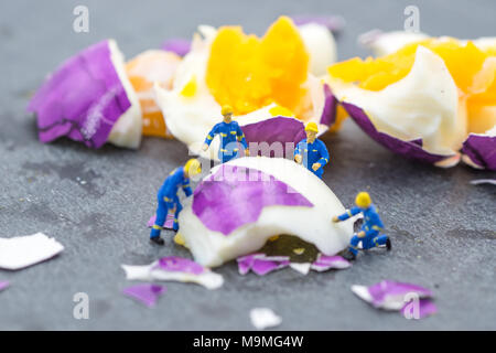 miniature worker people working on egg cleaning concept Stock Photo