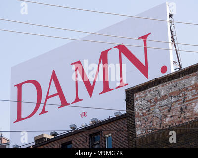 DAMN. Gardner Expressway visible billboard: A large billboard with the single word damn in large red letters graces an old building in Old Toronto. It is an ad for a new Kendrick Lamar album. Stock Photo
