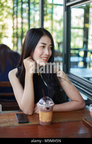 beautiful woman with ice chocolate in the cafe Stock Photo