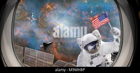 Astronaut holding USA flag on Crap Nebula cloud by artist expression of futuristic ISS. Altered composite from elements image furnished by NASA. Stock Photo