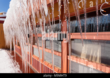 Large icicles hanging from a building. Muskoka, Ontario, Canada. Stock Photo
