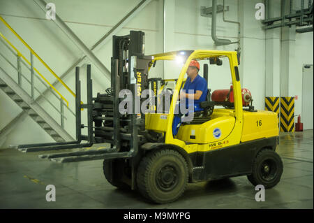 Tobolsk, Russia - July 15. 2016: Sibur company. Polymer plant. Driver on forklift truck loads pallets with finished goods from packaging machine Stock Photo