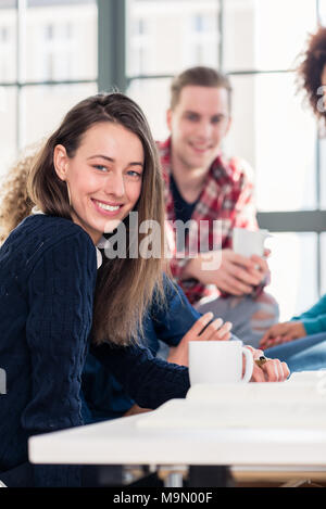 Millennial students watching together an online funny video Stock Photo