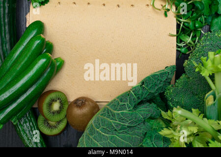 fresh green vegetables and fruits with notebook Stock Photo
