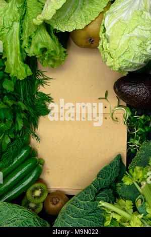 fresh green vegetables and fruits with notebook Stock Photo