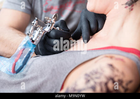 Trendy woman smiling while getting a painless new tattoo Stock Photo