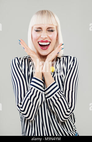 Excited Woman holds cheeks by hand. Beautiful girl with bob hairstyle surprised and shocked. Expressive facial expressions businesswoman Stock Photo