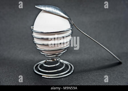 Chicken egg in eggcup with spoon Stock Photo