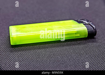 Green lighter on black background Stock Photo