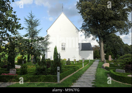 Romanesque Jelling kirke (church) built in 1100. The royal seat of first kings of Denmark with large stone ship, two large burial mounds, the Jelling  Stock Photo
