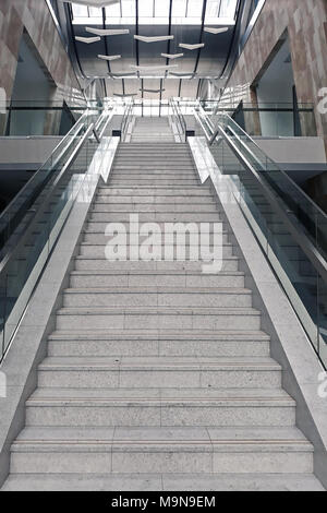 Front staircase with marble steps, going to the upper floors of the building. Stock Photo