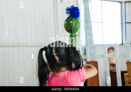 A little girl playing with a toy that has the shape of an octopus Stock Photo