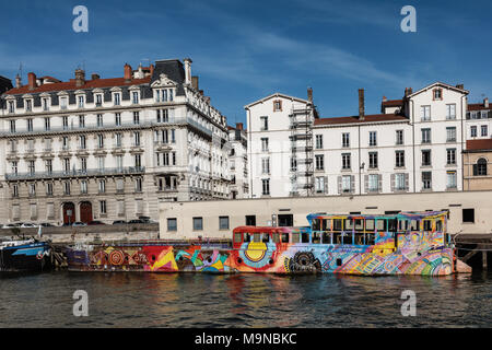 A colourful barge on the Saone river taken from a pleasure cruiser boat, Lyon, France. Stock Photo