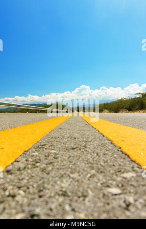 two yellow dividing strips on asphalt road. Speed highway Stock Photo