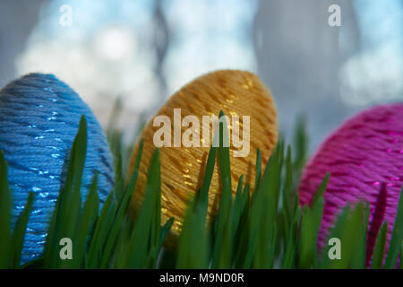 Easter Craft Ideas. The Easter egg decorated with multicolored paper,  placed between frech green wheat germs. Stock Photo