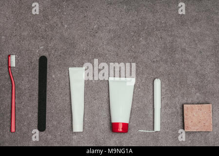 top view of arrangement of feminine hygiene supplies on grey surface Stock Photo