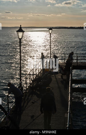 View out across the Solent from Victoria Pier by Square Tower Old Portsmouth, Portsmouth with fishermen enjoying the sunshine. Stock Photo