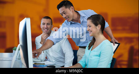 Composite image of business people discussing over computer Stock Photo