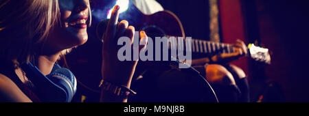 Female singer with guitarist on stage Stock Photo