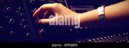 Cropped hand of audio engineer using sound mixer Stock Photo