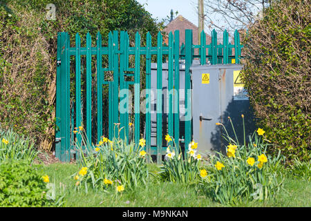 Small electricity substation fenced off in a residential area in the UK. Stock Photo