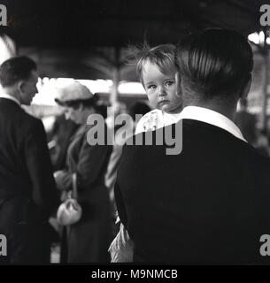 1959, historical, holding a daughter, a father at an event outside holding close his precious little girl, England, UK. Stock Photo