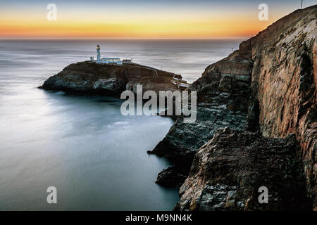 Sunset over South Stack lighthouse, Anglesey, North Wales, UK Stock Photo