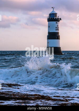 The Trwyn Du lighthouse watches over the treacherous waters between Penmon Point and Puffin Island, south east Anglesey, Wales, UK Stock Photo