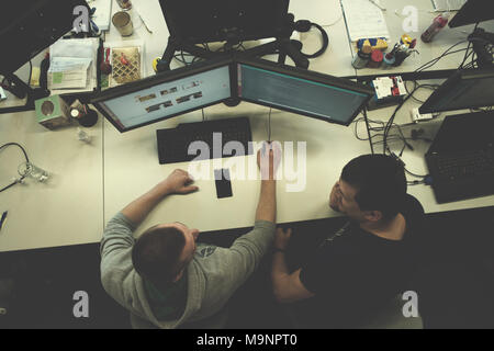 top view of software developers writing programming code on computer Stock Photo