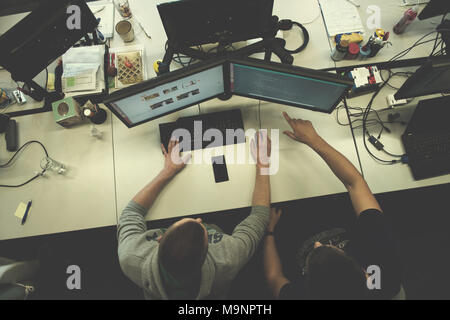 top view of software developers writing programming code on computer ...