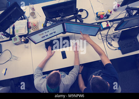 top view of software developers writing programming code on computer Stock Photo