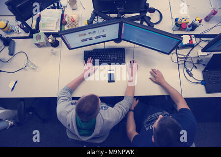 top view of software developers writing programming code on computer Stock Photo