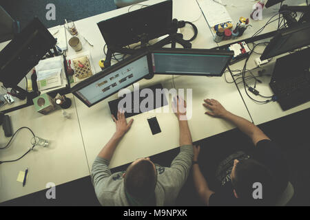 top view of software developers writing programming code on computer Stock Photo
