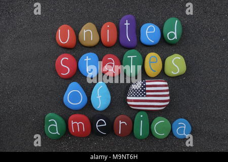 United States of America with multicolored stones and national flag over black volcanic sand Stock Photo