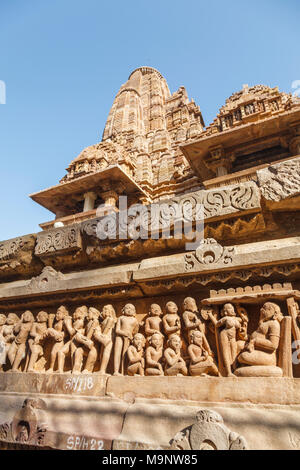 The famous ancient carvings at a Hindu temple in the Western Group of the Khajuraho Group of Monuments at Khajuraho, Madhya Pradesh, India Stock Photo