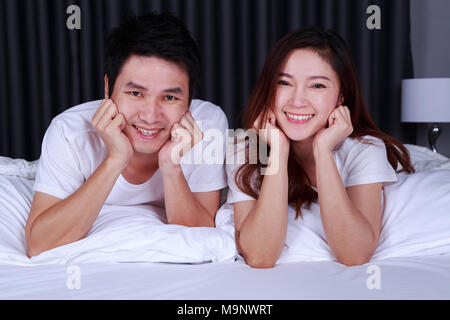 happy young couple on bed in the bedroom Stock Photo
