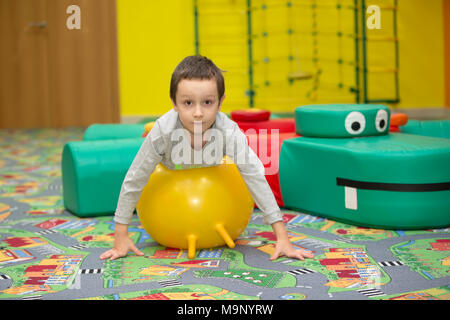 Belarus, Gomel, November 9, 2017. Gomel Children's Center.Occupation on a rubber gymnastic ball. Child in the gym. Stock Photo