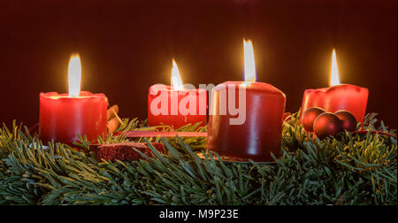 Four burning red candles on Advent wreath, studio shot Stock Photo