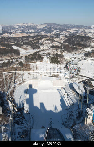View from the top of the Olympic ski jumping tower.  Alpensia Ski Jumping Stadium is a multi-purpose stadium located at Alpensia Resort in Pyeongchang, South Korea. It will host ski jumping events during the 2018 Winter Olympics.   The Alpensia Resort is a ski resort and a tourist attraction. It is located on the territory of the township of Daegwallyeong-myeon, in the county of Pyeongchang, hosting the Winter Olympics in February 2018.  The ski resort is approximately 2.5 hours from Seoul or Incheon Airport by car, predominantly all motorway.   Alpensia has six slopes for skiing and Stock Photo