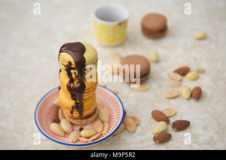 delicious chocolate macaroons drizzled in chocolate sauce on marble Stock Photo