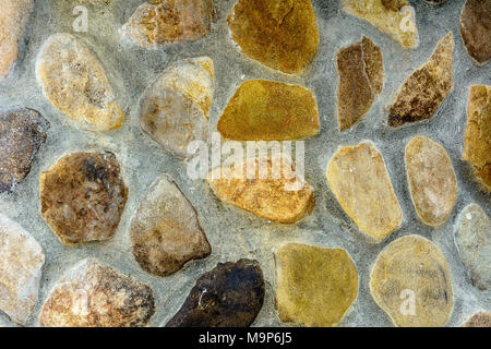 Amazing background of textured river stones laid out on a cement mortar 2018 Stock Photo