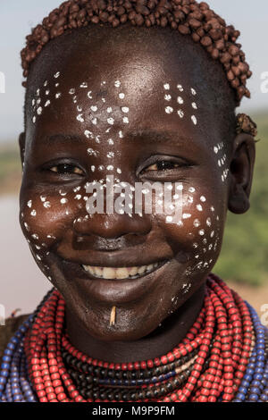 Young woman with face painting, portrait, laughing, Karo tribe, Southern Nations Nationalities and Peoples' Region, Ethiopia Stock Photo