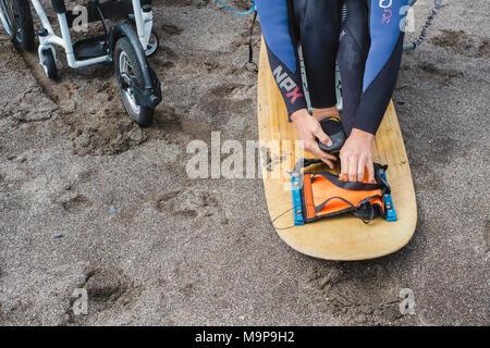 Close up of the legs of a handicapped kite surfer on his board Stock Photo