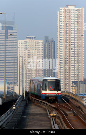 BTS Skytrain in front of skyscrapers, on Saphan Taksin Bridge, Sathon, Bangkok, Thailand Stock Photo